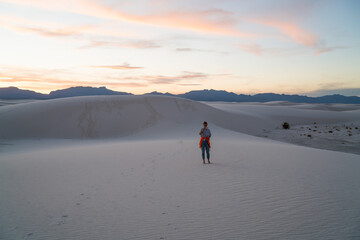 Unrecognizable woman in white sand desert
