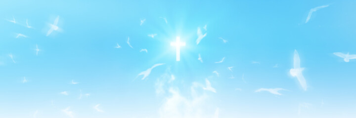 Christian cross appears bright in the sky background and soft clouds. with the light shining as...