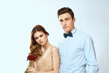 Cheerful young couple romance embrace relationship red rose lifestyle light background