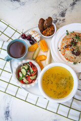 .chicken soup with salad and bread on a bell tablecloth