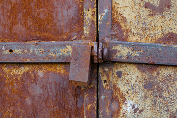 Old door with an old lock. Old padlock.