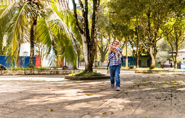 Fototapeta na wymiar 8-10 year old boy walking with a dog in the park