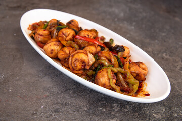 .fried dumplings in a white plate on a concrete background