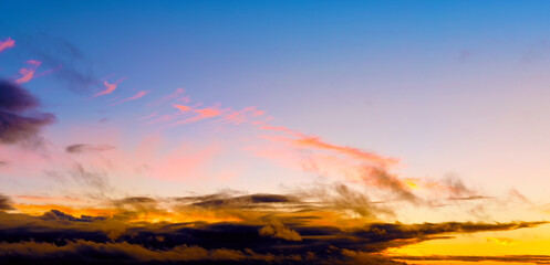 autumn sunset sky landscape background panorama. Natural color of evening dark clouds. Cloudscape with sun below horizon. Ultra wide panoramic view