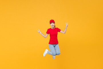 Fototapeta na wymiar Full length body fun delivery employee woman in red cap blank t-shirt uniform work courier in service during quarantine coronavirus covid-19 virus jumping isolated on yellow background studio portrait