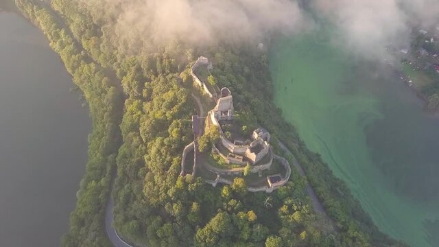 Cornstein Medieval castle in South Moravia region during amazing sunrise, Czech republic, Europe. Aerial drone view. Summer or autumn time. Misty and sunny atmosphere.