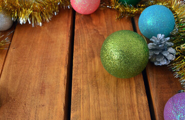 New Year's layout on a wooden background. Christmas decorations for the tree, balls, gifts.