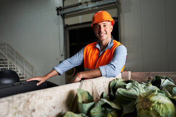 Dedlivery worker standing near box with cabbages