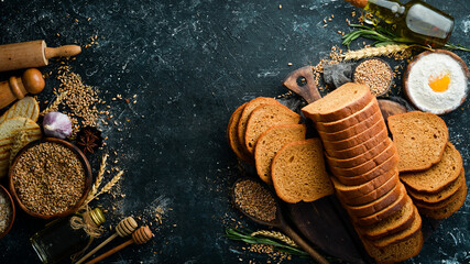 Fresh bran bread on an old kitchen table. Baking from rye and flour. Top view. Rustic style.