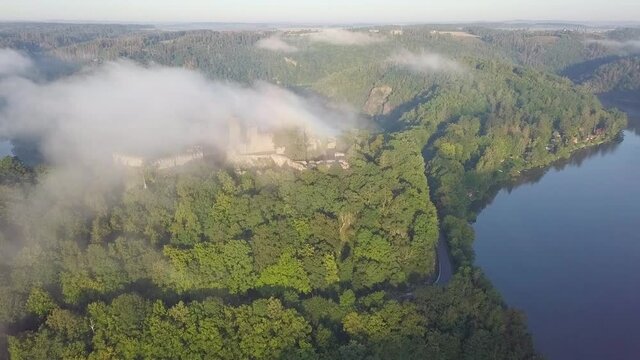 Cornstein Medieval castle in South Moravia region during amazing sunrise, Czech republic, Europe. Aerial drone view. Summer or autumn time. Misty and sunny atmosphere.