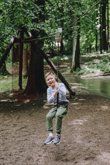 little toddler 6 years boy having fun at playground