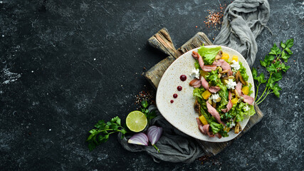 Vegetable salad with mushrooms and bacon on a plate. Top view. free space for your text. Rustic style.