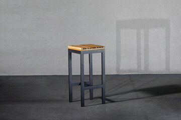 Closeup of a loft-style stool on the gray background