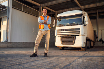 Delivery worker standing near his vehicle