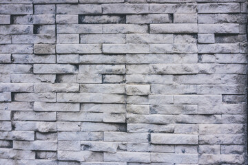 Close up of a gray brick wall texture for background. Weathered light brick pattern