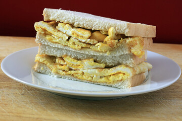An isolated omelette sandwich on a plate.