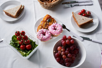 Delicious food and cutlery on white table