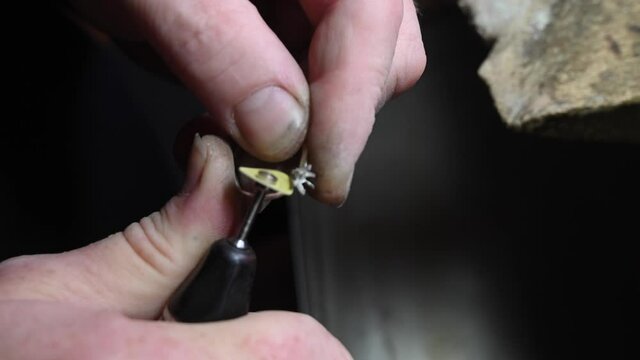 Closeup of wedding ring polishing by caicasian jeweler isolated, 4k footage