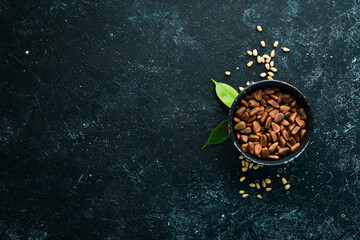 Cedar nuts in the shell, in a bowl. free space for your text. Top view.