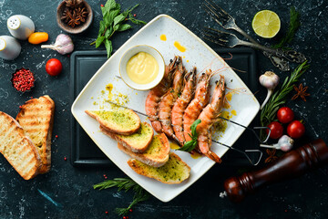 Grilled shrimp with cheese sauce and garlic. Top view. Free space for text.