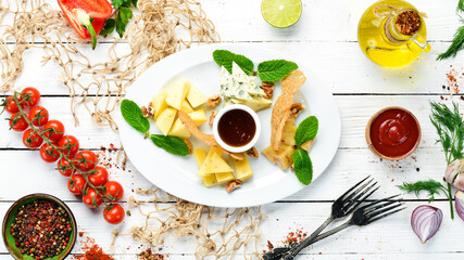 Assorted cheeses. Cheese slicing on a plate. Top view. free space for your text. Rustic style.