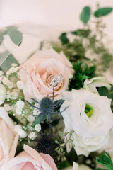 Obraz na płótnie Canvas Wedding ring set inside pink roses, wedding detail photo