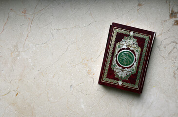 Obraz na płótnie Canvas Islamic Book Koran (or Quran) on marble table