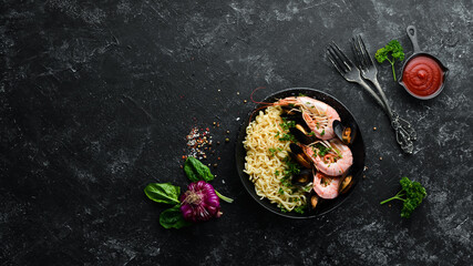 Asian Traditional Cuisine. Noodles with prawns and mussels. Seafood dishes. Top view. Free space for your text.