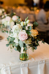 Beautiful wedding bouquet in  a vase at a wedding reception. 