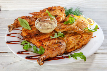 baked grilled chicken with garlic sauce, herbs and lemon