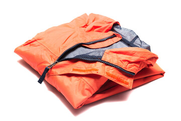 Folded orange zipper windbreaker jacket, rain proof and waterproof hiking Gore-Tex jacket hoodie. Track jacket sport nylon full zip isolated on white. Folded clothes. Outer layer garment for travel.