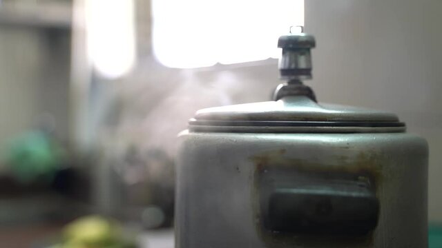 Steam Came From A Boiling Pressure Cooker At The Kitchen. - Close Up Shot