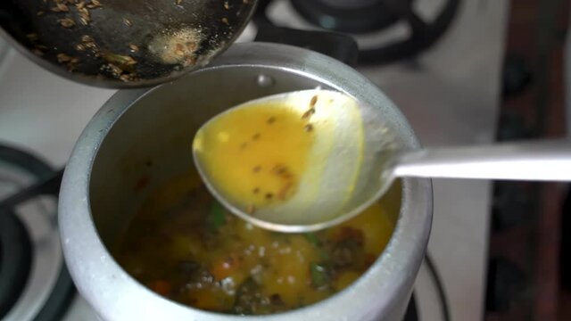 Seasoned The Sambar Dish Over A Stove With Garam Masala For Added Flavor. - High Angle Shot