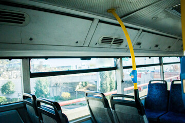 The interior of an empty bus at noon