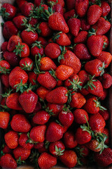 Ripe fresh strawberries close-up in a container for sale. Healthy diet