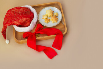 Christmas puff pastry copy space, cookies in star shapes. Sweet buns on tray with santa's hat and...