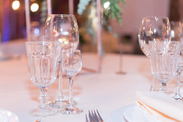 glasses on the festive table in the evening lights
