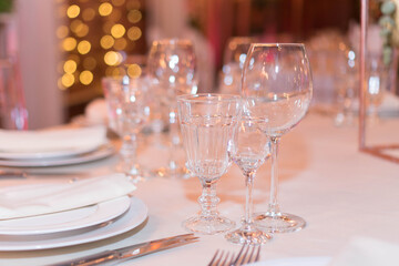 glasses on the festive table in the evening lights