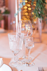 glasses on the festive table in the evening lights