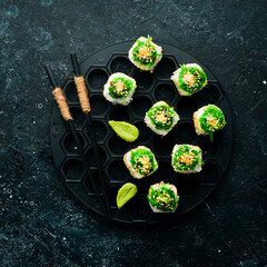 Sushi rolls - Kyoto with salmon, cucumber and Chuka salad. Sushi menu bar. Japanese food