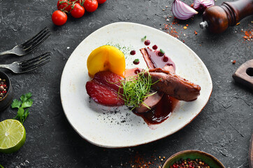 Baked duck fillet with pear and cranberry sauce. Top view. free space for your text. Rustic style.