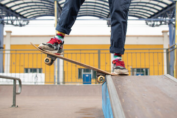 a young guy is engaged in jumping on a skateboard. an old skateboard. active sport among young people. injury-prone sport