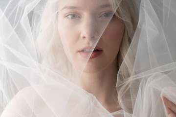 Attractive young woman wearing beautiful white veil