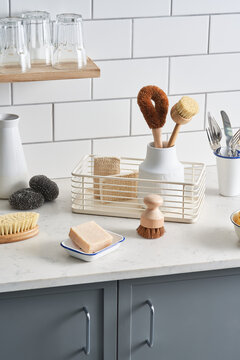Cleaning supplies and dishware in kitchen