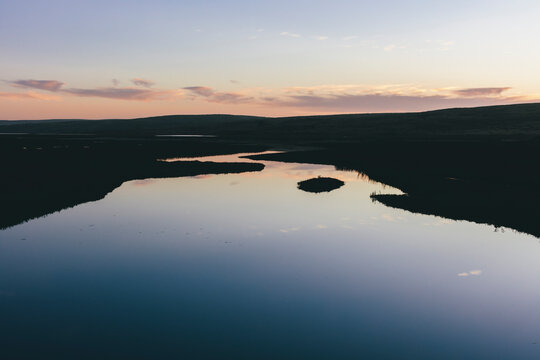 Calm tidewaters in intertidal estuary at dusk