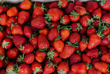 Ripe fresh strawberries close-up in a container for sale. Healthy diet