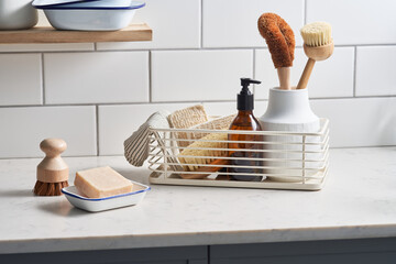 Cleaning supplies on kitchen cupboard