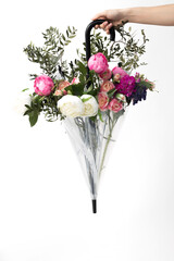 Young woman hand holding umbrella with flowers