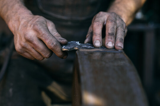 Crop blacksmith sharping blade - Powered by Adobe