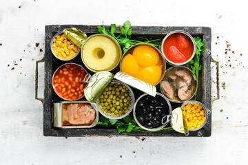 Fototapeta na wymiar Food stocks. Food in tin cans. Vegetables, fruits, fish, meat and legumes are marinated in jars.